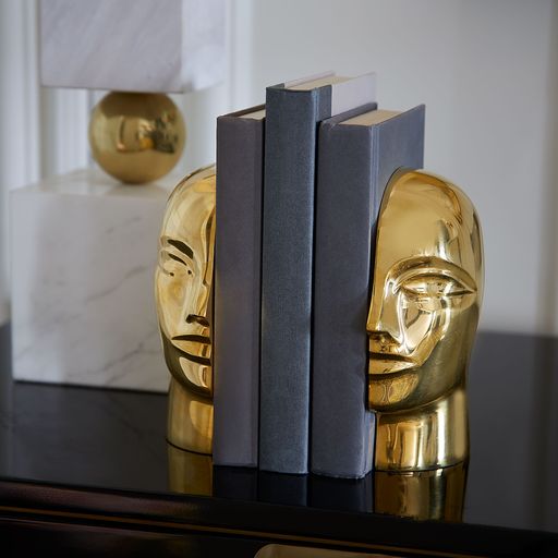 Glänzende BRASS ATLAS Buchstützen auf weißem Hintergrund